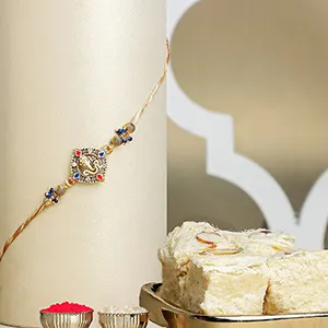 Celestial Ganesha Serenade Rakhi with Soan Papdi Combo