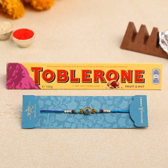 Circular Peacock Feather Rakhi And Toblerone Chocolate