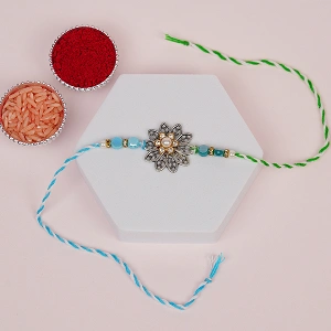Vintage Silver Floral Rakhi with Blue Beads