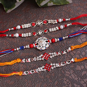 Interesting stone studded silver Rakhis set