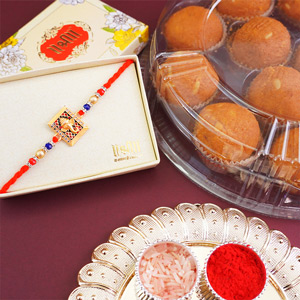 Auspicious Golden Ganpati Rakhi with Sweets