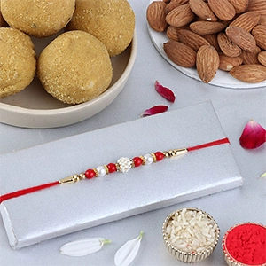 Nityam Creation Regular Ethnic Pearl Rakhi with Besan Laddoo