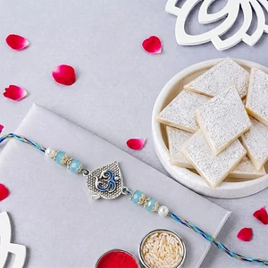 Blue Serenity Om Rakhi with Kaju Katli