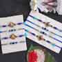 Set of 2 Ganesha Rakhi, 2 Peacock Rakhi and 4 Evil Eye Rakhi