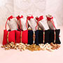 Set of 5 Rakhis with Dry Fruits Potlis