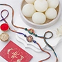 Vibrant Ganesh and Om Rakhi Duo N Rasgulla Delight