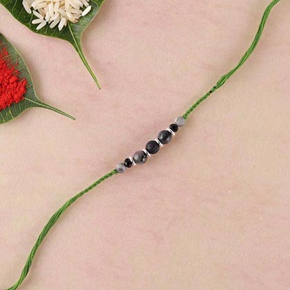 Lava and Grey agate rakhi in twisted green thread rakhi