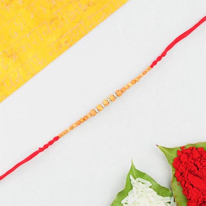 Wooden Beads Rakhi in Red Cotton Thread