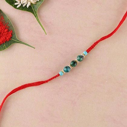Green agate and stab turquoise beads rakhi in flat woven red thread