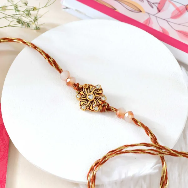 Floral Shaped Rakhi Gift Combo with Soan Papdi