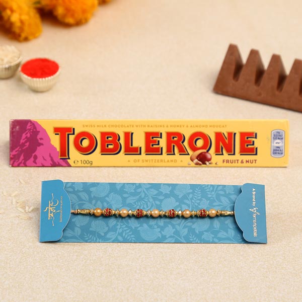 Traditional Golden Pearl Rakhi And Toblerone Chocolate