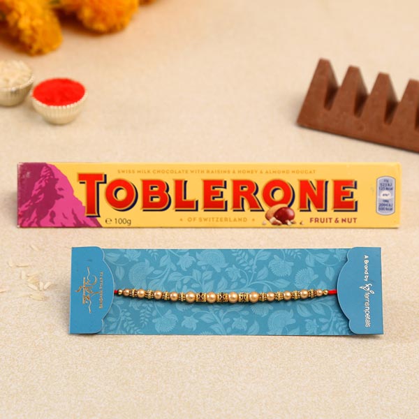 Traditional Pearl Mauli Rakhi And Toblerone Chocolate