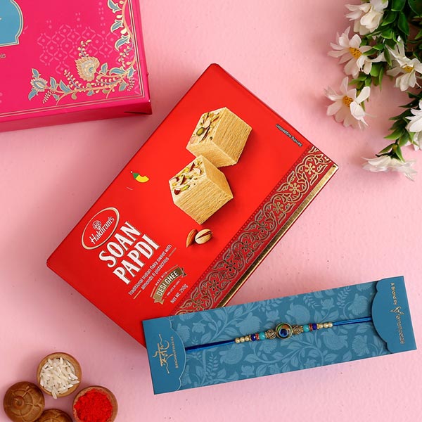 Circular Peacock Feather Rakhi And Soan Papdi