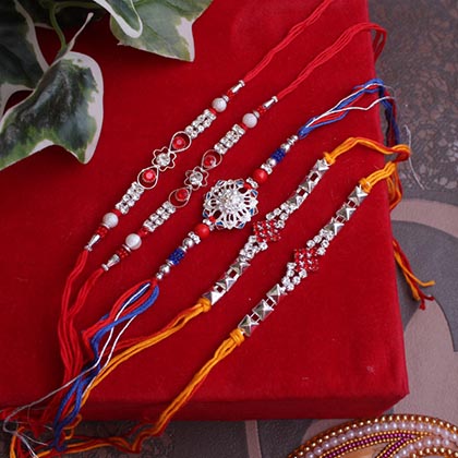 Interesting stone studded silver Rakhis set