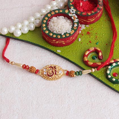 Captivating Om Rakhi with Sweets: & Thali