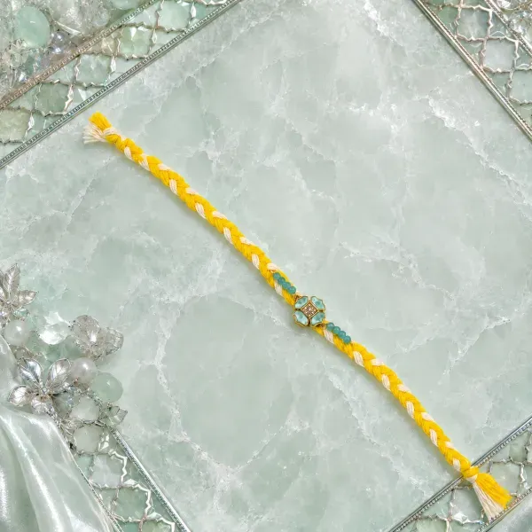 Elegant Yellow Thread Floral Design Rakhi with Roli Chawal