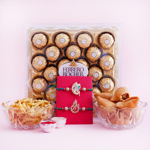 Two Auspicious Golden Rakhi with Sweets and Snacks
