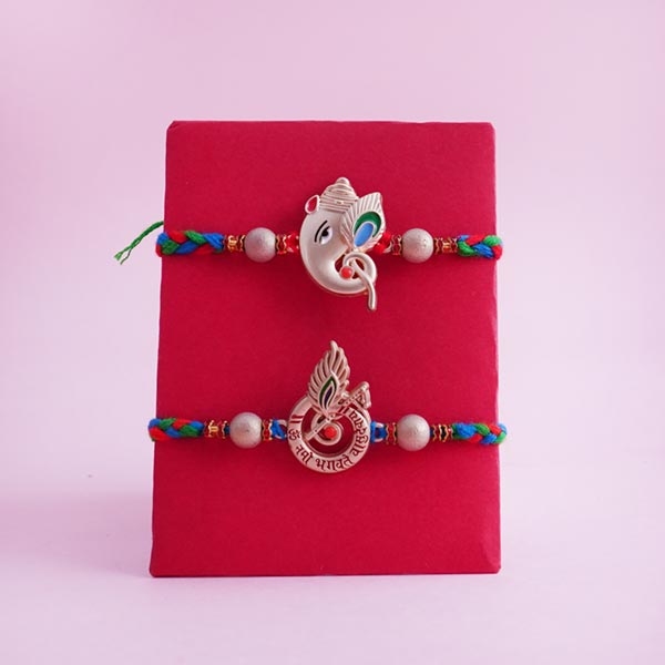 Two Auspicious Golden Rakhi with Sweets and Snacks