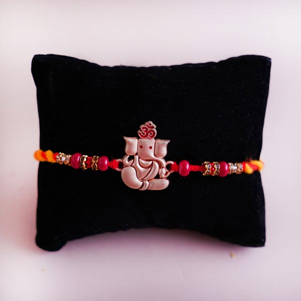 Auspicious Rakhi with  Dryfruits and Sweets Hamper
