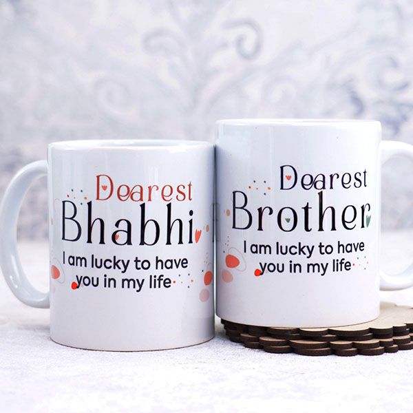 Dearest Brother Bhabhi Mugs N 2 Rakhi with Chocolates Gift Hamper