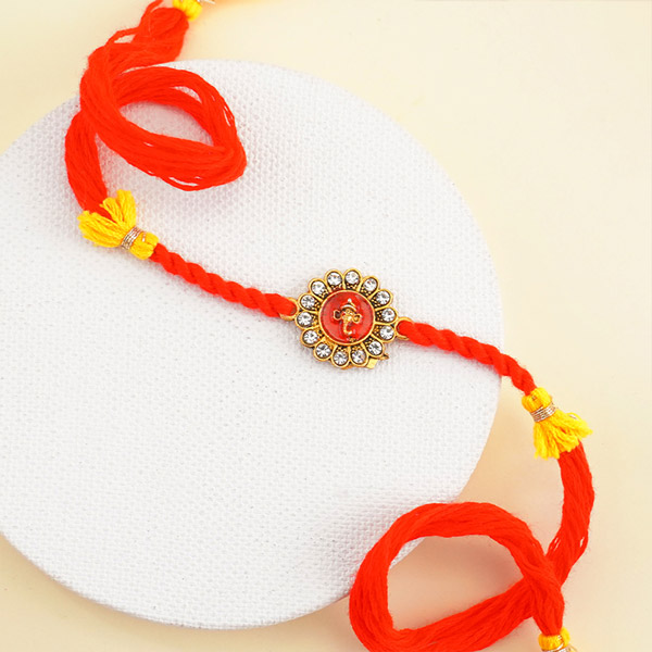 Sacred Golden Ganesha Rakhi with Sweets for Brother