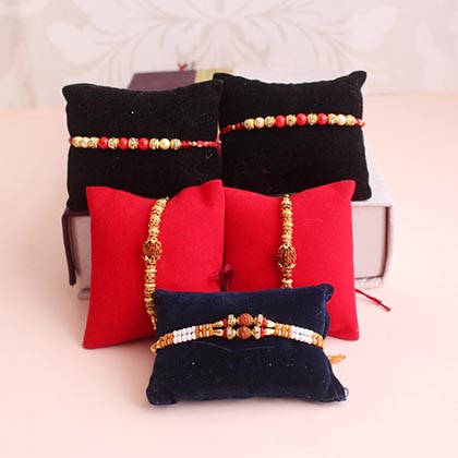 Set of 5 Rakhis with Dry Fruits Potlis