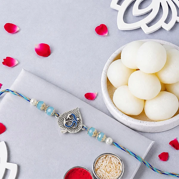 Blue Serenity Om Rakhi with Rasgulla