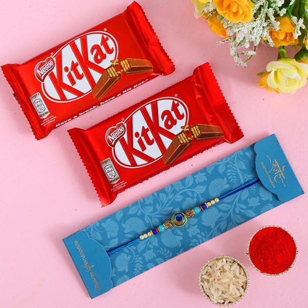 Circular Peacock Feather Rakhi And 2 Pcs Of Kitkat