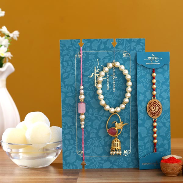 Caged Bird Lumba Rakhi Set & Om Rakhi With Rasgulla