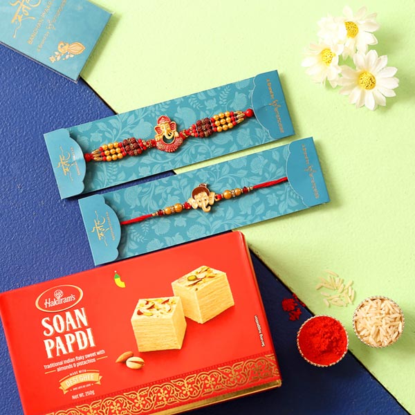 2 Lord Ganesha Rakhis & Soan Papdi Combo