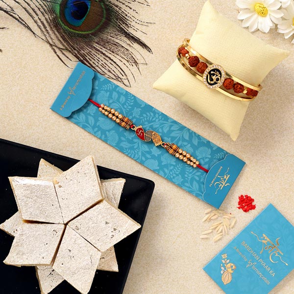 Om Bracelet & Red Peacock Rakhis With Kaju Katli