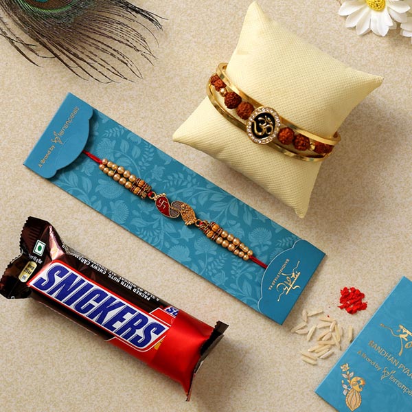Om Bracelet & Red Peacock Rakhis With Snickers
