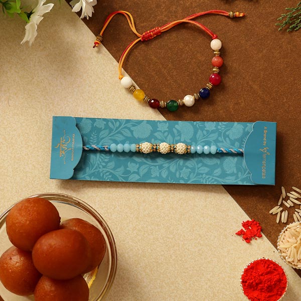 Set Of 2 Ethnic Pearl Rakhis & Gulab Jamun Tin
