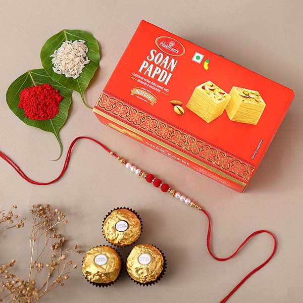 White Pearl And Velvet Beads Rakhi with 250 Grams Soan Papdi and 3 Ferrero Rocher