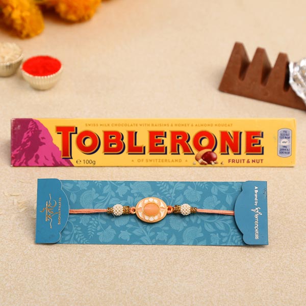 White Peach Stone Designer Rakhi And Toblerone Chocolate