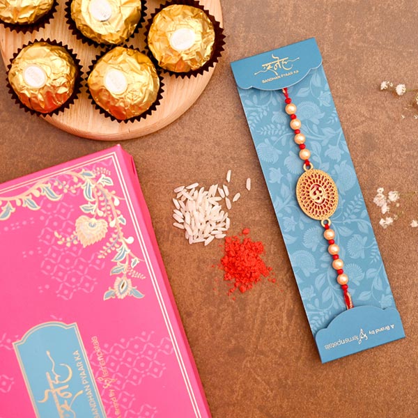 Spiritual Om Pearl Rakhi And 3 Pcs Ferrero Rocher