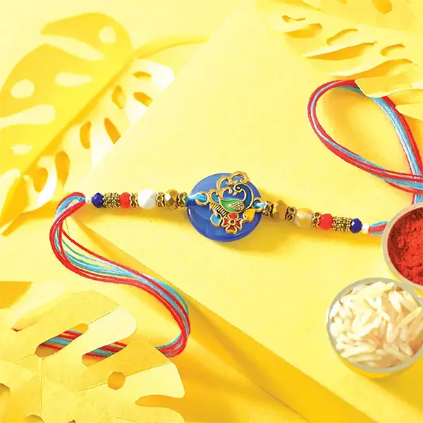 Charismatic Sweet Rakhi with 125gm Lindit bar and 250gm Soan Papdi for USA Brother