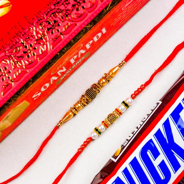 White Golden Pearl Set of 2 Rakhis With Soan Papdi & Snickers