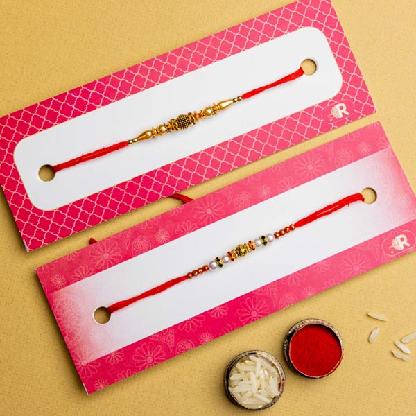 White Golden Pearl Set of 2 Rakhis With Soan Papdi & Snickers